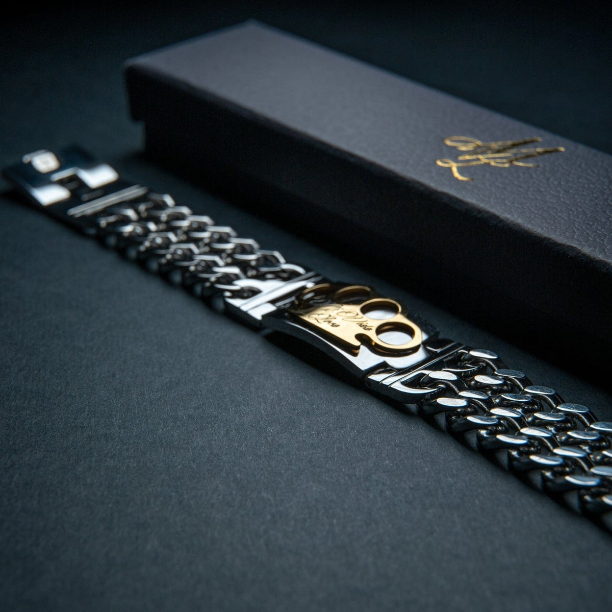 Mi Vida Loca MVL bracelet in silver with gold MVL logo plate next to the black gift box