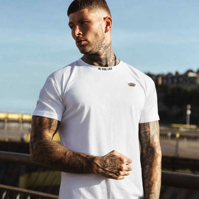 Model in het witte MVL Winning T-shirt, vooraanzicht met gouden logo op de borst